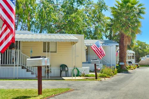 A row of mobile homes with american flags and mailboxes.