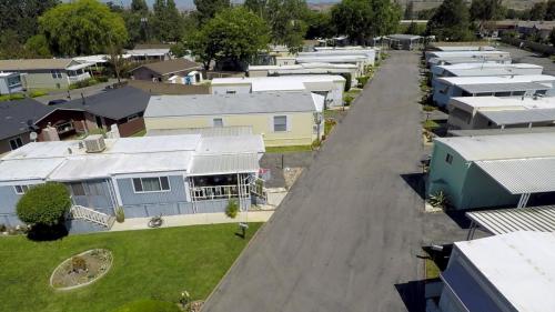 An aerial view of a row of mobile homes.