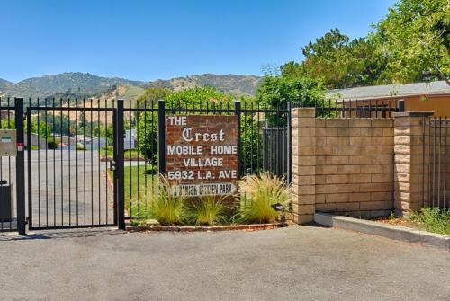 The gated entrance to a gated community with mountains in the background.