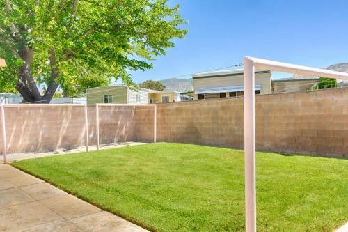 A backyard with grass and a fence.