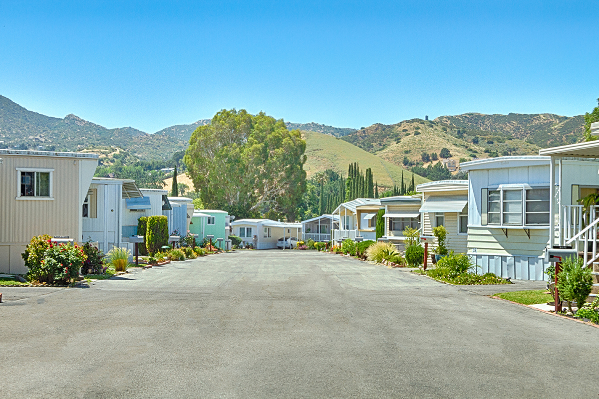 mobile home street with hills in the distance